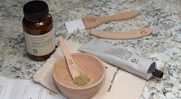 Wooden bowl and spoons with green tea powder and skincare tube on cloth. Wooden bowl and spoons with green tea powder and skincare tube on cloth.
