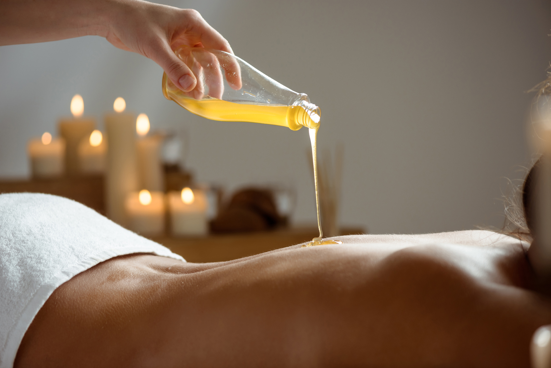 Pouring warm oil for a relaxing massage. Pouring warm oil for a relaxing massage.