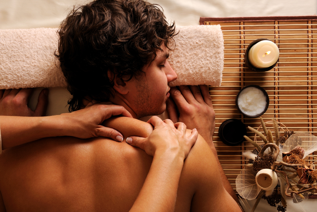A man receiving a relaxing shoulder massage at a spa. A man receiving a relaxing shoulder massage at a spa.